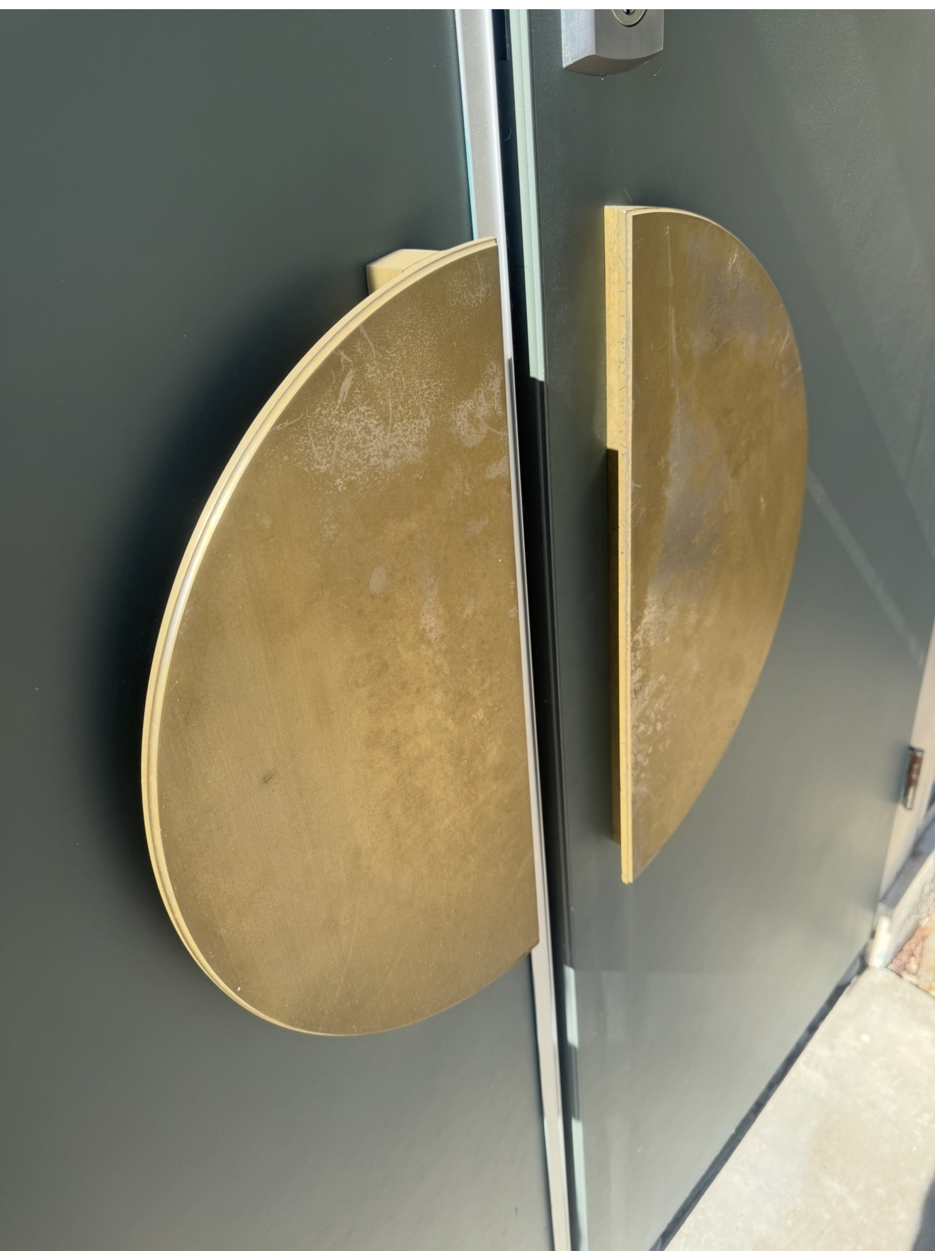 Pitted brass entry door pulls before brass polishing in Palm Desert