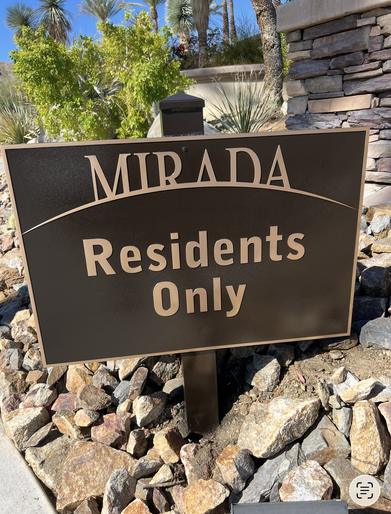 Restored cast bronze community entry plaque with polished lettering after on-site refinishing in Palm Springs