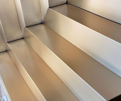Stainless steel architectural panels and steps refinished to an even brushed grain finish
